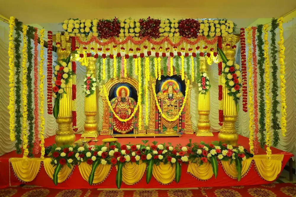 Traditional wedding stage dressed in marigold and jasmine with golden pillars